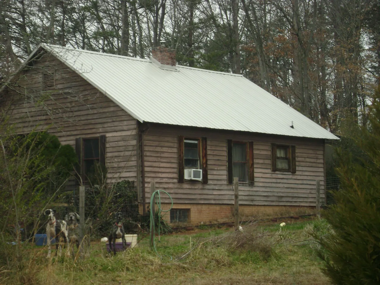 White metal roof on an old wood sided farmhouse, from a Metal Roof Installation job in Kendallville